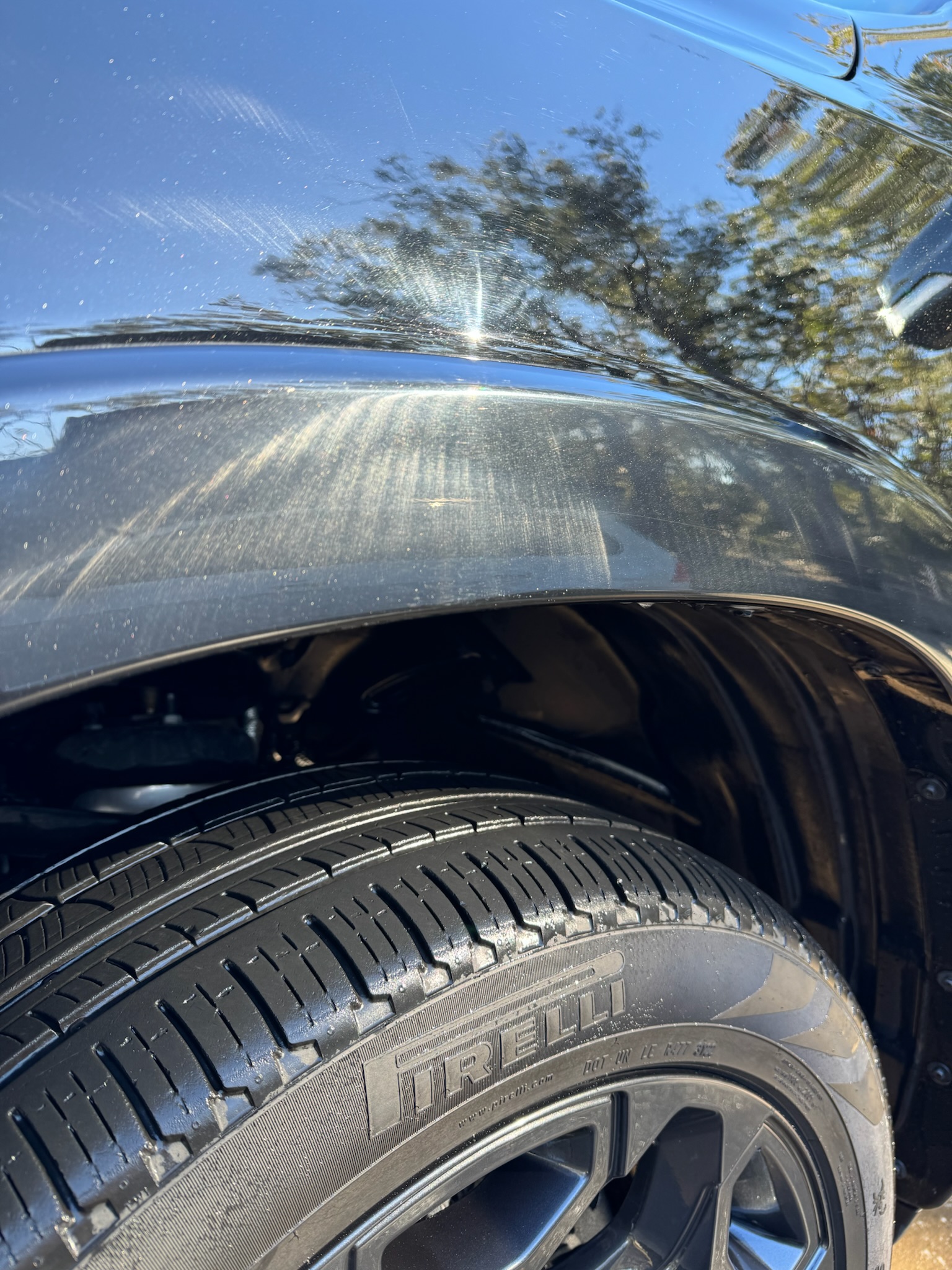 Before: swirl marks on black paint panel